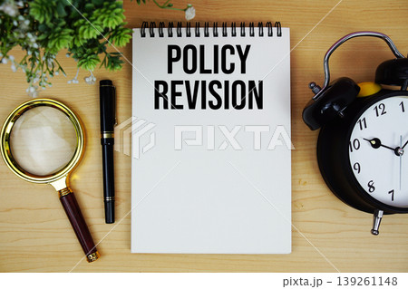 Policy Revision text written on notepad with alarm clock and magnifying glass flat lay on wooden background Policy Revision text written on notepad with alarm clock and magnifying glass flat lay on wooden background 139261148
