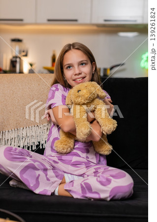 Teenager girl hugs soft toy dog plush smile warm cuddle gentle touch shows kind mood cute moment joy 139261824