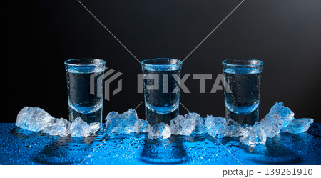 Vodka and crushed ice on a black table. 139261910