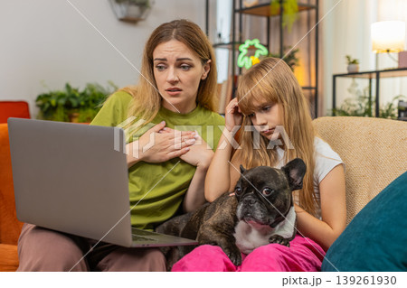 Mother daughter dog lose contest or game on laptop sigh feel sad support each other hug family care 139261930