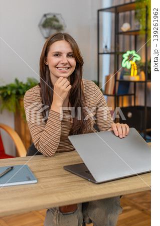 Young woman closes laptop with relief smiles as project is sent and work finished milestone reached Young woman closes laptop with relief smiles as project is sent and work finished milestone reached 139261962