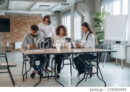 Unfinished room, brick wall. Group of people are working in the office together as a team 139262085