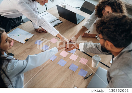 Blue and pink colored. Office workers are by the table with paper stickers, brain storming Blue and pink colored. Office workers are by the table with paper stickers, brain storming 139262091