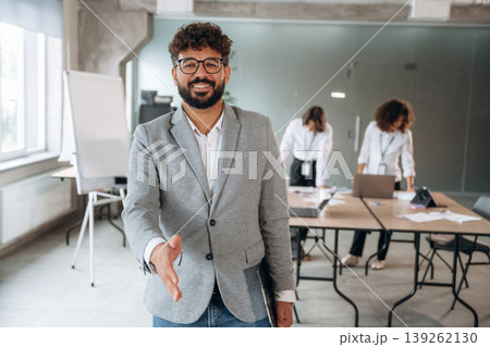 Giving a hand to shake. Group of people are working in the office together as a team 139262130