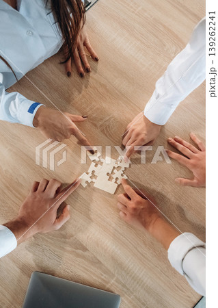Top view of office workers that are playing puzzle game, conception of success Top view of office workers that are playing puzzle game, conception of success 139262241