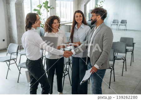 Doing handshake, deal. Group of people are working in the office together as a team 139262280