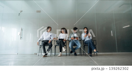 Potential workers. People near the wall, waiting for a job interview Potential workers. People near the wall, waiting for a job interview 139262302