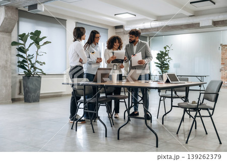 Papers, documents, reading, sharing data. Group of people are working in the office together as a team 139262379