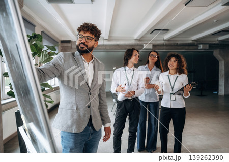 Explaining the problem with a project. Four office workers are together, employees at work 139262390