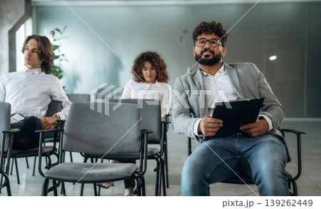 Looking forward, sitting. People are sitting on the meeting, education presentation, business conception 139262449