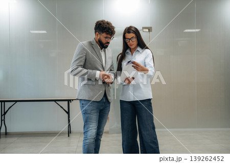Important documents about project. Man and woman are working in the modern office, business conception 139262452