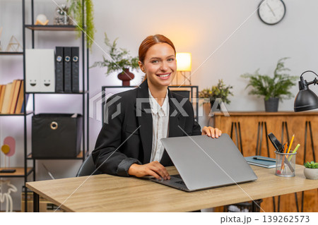 Young businesswoman closes laptop proud finishing project looking at camera satisfied with success 139262573
