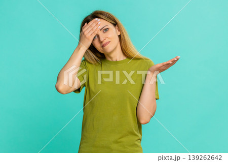 Woman making facepalm and rubbing forehead showing disappointment regret sudden realization moment Woman making facepalm and rubbing forehead showing disappointment regret sudden realization moment 139262642