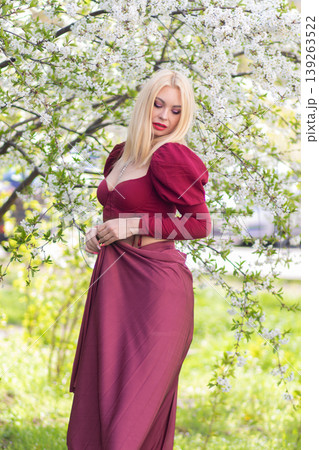 Blonde Woman Side Pose With Burgundy Skirt In Blossoms 139263522