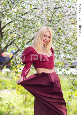 Smiling Blonde Woman Swinging Burgundy Skirt In Spring Smiling Blonde Woman Swinging Burgundy Skirt In Spring 139263523