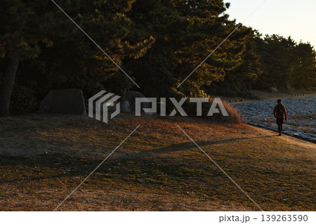 日の出の葛西臨海公園 朝日に照らされた道を歩く人のシルエット 日の出の葛西臨海公園 朝日に照らされた道を歩く人のシルエット 139263590