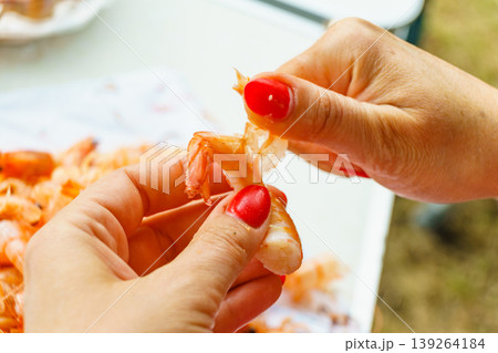 Hand peeling raw fresh shrimp. Hand peeling raw fresh shrimp. 139264184