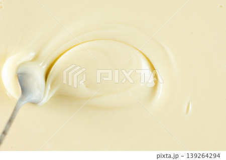 Spoon in a swirl of sweet condensed milk. Spoon in a swirl of sweet condensed milk. 139264294