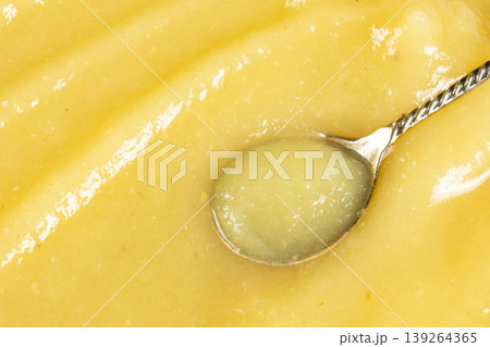 Organic applesauce in a spoon macro texture 139264365