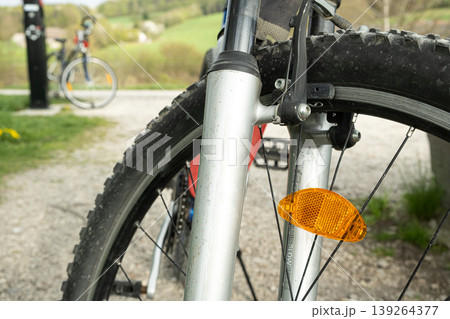 Safety reflector attached to bike spokes for night visibility. 139264377