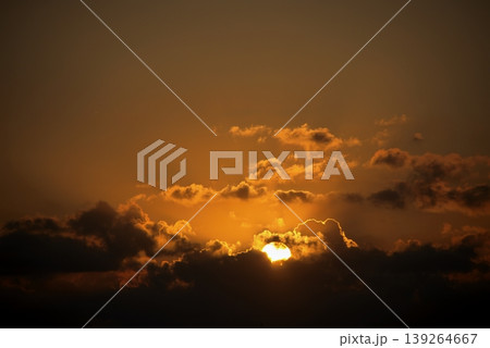 Dramatic Sunset Sky with Golden Sun and Dark Clouds. Intense, beautiful nature background. 139264667