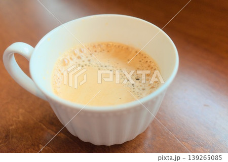 木目のテーブルに置かれた白いカップのカフェオレ 木目のテーブルに置かれた白いカップのカフェオレ 139265085