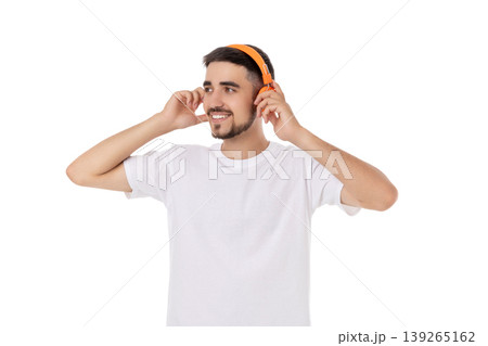 Man listens to music using vibrant headphones indoors, isolated, PNG Man listens to music using vibrant headphones indoors, isolated, PNG 139265162
