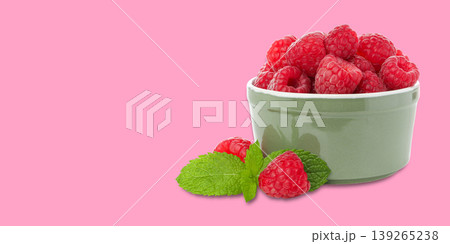 Bowl with fresh raspberries and mint leaves on a table 139265238