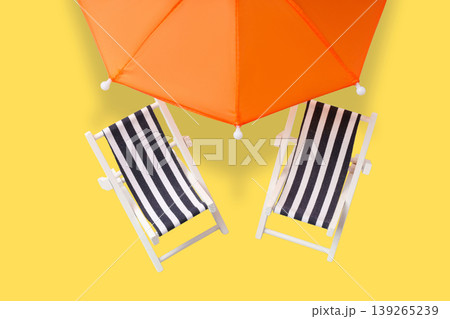 Beach chairs and an umbrella set up for summer relaxation 139265239