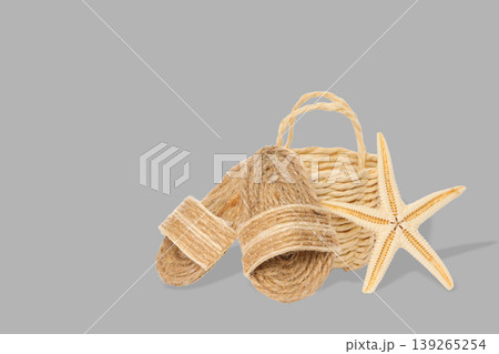 Basket and sandals with a starfish for beach setup Basket and sandals with a starfish for beach setup 139265254