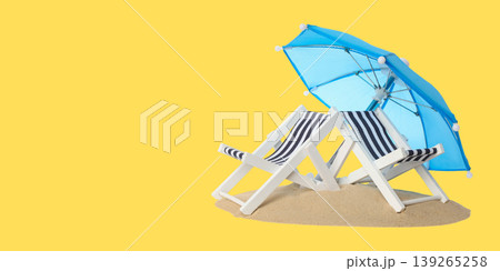 Beach chairs and an umbrella set up on sandy shore at summer Beach chairs and an umbrella set up on sandy shore at summer 139265258