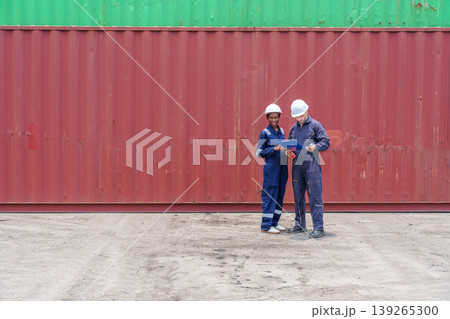 Diverse logistics supervisors standing at a shipping terminal to manage inventory and international trade operations near large freight containers, perfect for distribution industry ads. Diverse logistics supervisors standing at a shipping terminal to manage inventory and international trade operations near large freight containers, perfect for distribution industry ads. 139265300