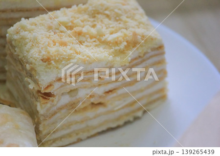 Delicious homemade Napoleon cake with delicate layers and custard cream closeup 139265439