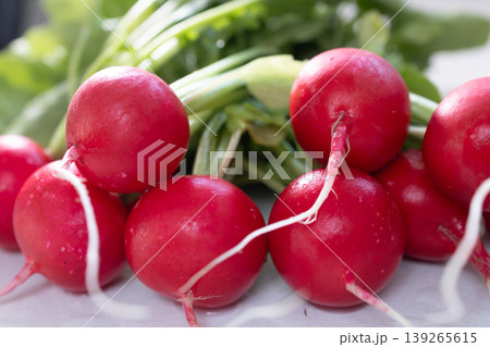 Fresh red radish with green leaves. Healthy vegetable as source of fiber and vitamin. Organic food ingredient for salad preparation 139265615
