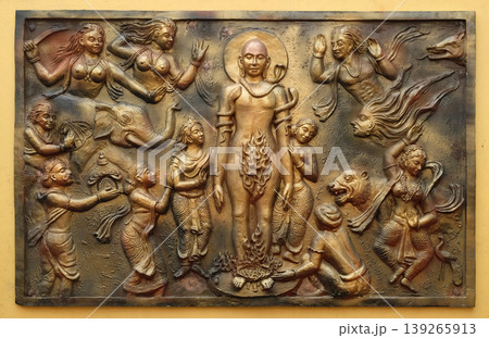 Jealous god Sangama tests Mahaviras enderance and, courage by twenty severe tests: Mahavira is victorius, Street bas relief on the wall of Jain Temple (also called Parshwanath Temple) in Kolkata, West Jealous god Sangama tests Mahaviras enderance and, courage by twenty severe tests: Mahavira is victorius, Street bas relief on the wall of Jain Temple (also called Parshwanath Temple) in Kolkata, West 139265913