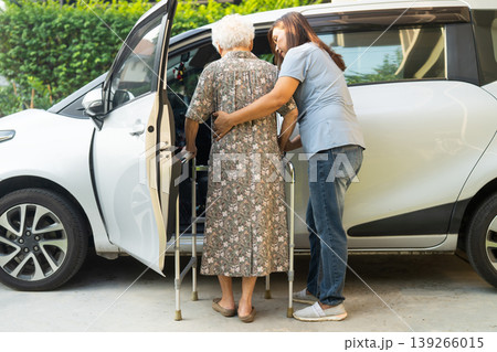 Caregiver help Asian elderly woman disability patient get into car. Caregiver help Asian elderly woman disability patient get into car. 139266015