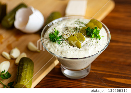 Traditional creamy cucumber garlic dressing in glass bowl Traditional creamy cucumber garlic dressing in glass bowl 139266513