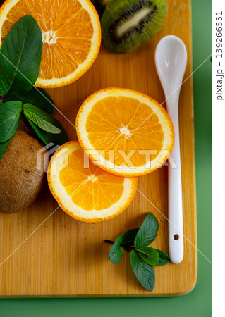 fresh fruit ingredients orange kiwi and mint on board 139266531