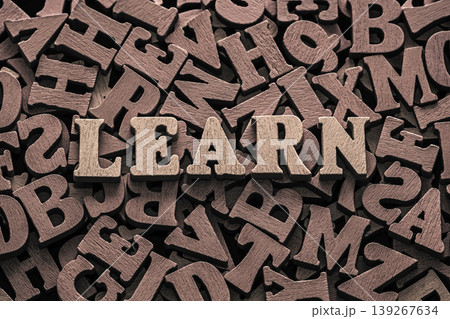 Inscription learn on pile of old vintage wooden letters. Inscription learn on pile of old vintage wooden letters. 139267634