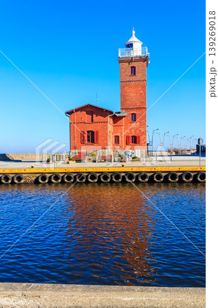 Old brick lighthouse at the Wieprza river mouth to the Baltic Sea in Darlowko, Poland 139269018