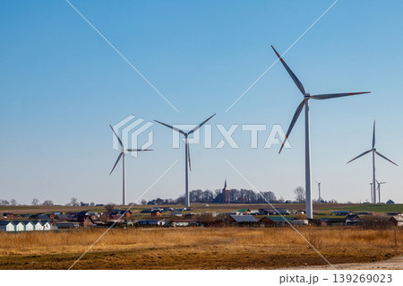 Wind turbines in a village. Renewable energy 139269023
