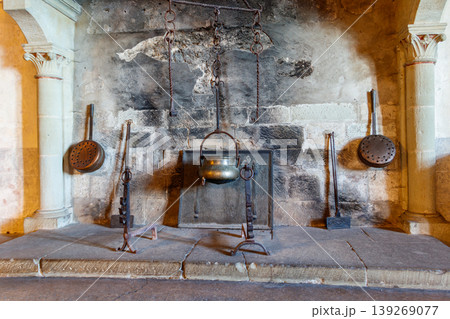 Fireplace in a castle with cooking utensils. Interior of Chillon castle in Switzerland Fireplace in a castle with cooking utensils. Interior of Chillon castle in Switzerland 139269077