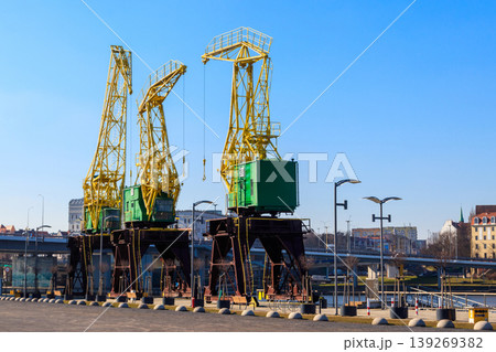 Old cranes on city boulevard in Szczecin, Poland Old cranes on city boulevard in Szczecin, Poland 139269382