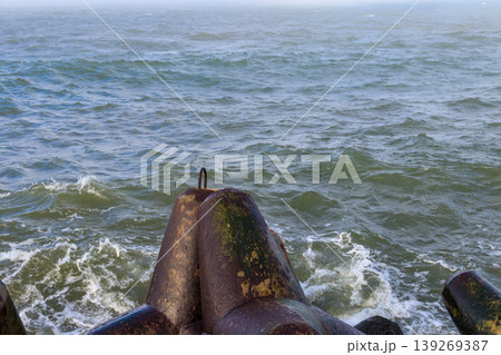 Storm in the Baltic sea. Storm waves crashing on the breakwater in Darlowo, Poland 139269387