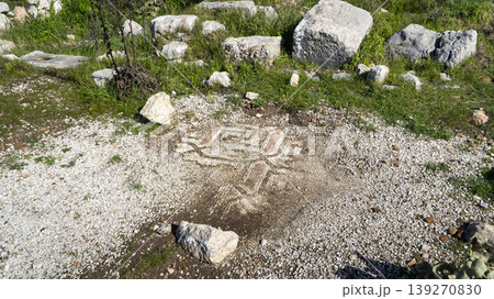 Geometric mosaic fragment at Xanthos ruins in Mugla, Turkey, showing weathered stone tesserae pattern partially exposed in soil Geometric mosaic fragment at Xanthos ruins in Mugla, Turkey, showing weathered stone tesserae pattern partially exposed in soil 139270830