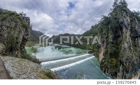 Turquoise waters of the Namnam River cascade over a stepped weir between moss covered rocky cliffs and dense pine forest in Mugla, Turkey Turquoise waters of the Namnam River cascade over a stepped weir between moss covered rocky cliffs and dense pine forest in Mugla, Turkey 139270845