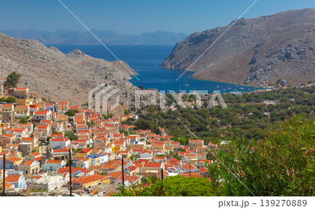 Symi village and bay panorama with hillside houses in Greece on sunny day Symi village and bay panorama with hillside houses in Greece on sunny day 139270889