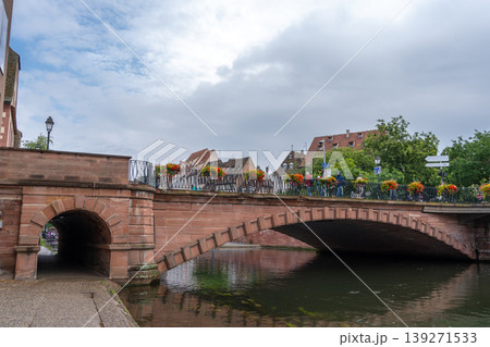Stone bridge with flowers crossing the Ill river Strasbourg, France Stone bridge with flowers crossing the Ill river Strasbourg, France 139271533