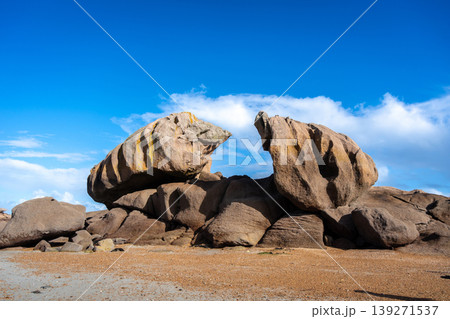 Jagged granite formations with golden lichens in Tregastel, Brittany, France 139271537