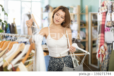 Young girl choosing summer dress in clothing store 139271744